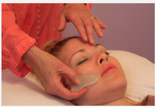 Tracy performing Gua Sha on client