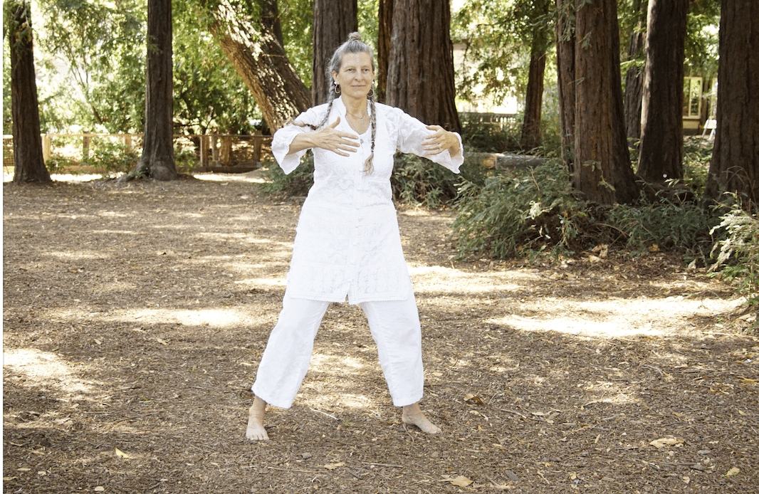 Tracy doing Mind pose in woods